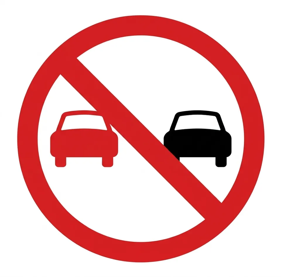 Round red-bordered sign showing two cars side by side, one red and one black, crossed by a red diagonal bar.