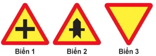 Ba biển tam giác nền vàng viền đỏ: biển 1 vẽ chữ thập đen, biển 2 vẽ mũi tên đứng đậm cắt bởi vạch ngang mảnh, biển 3 là tam giác ngược để trống.